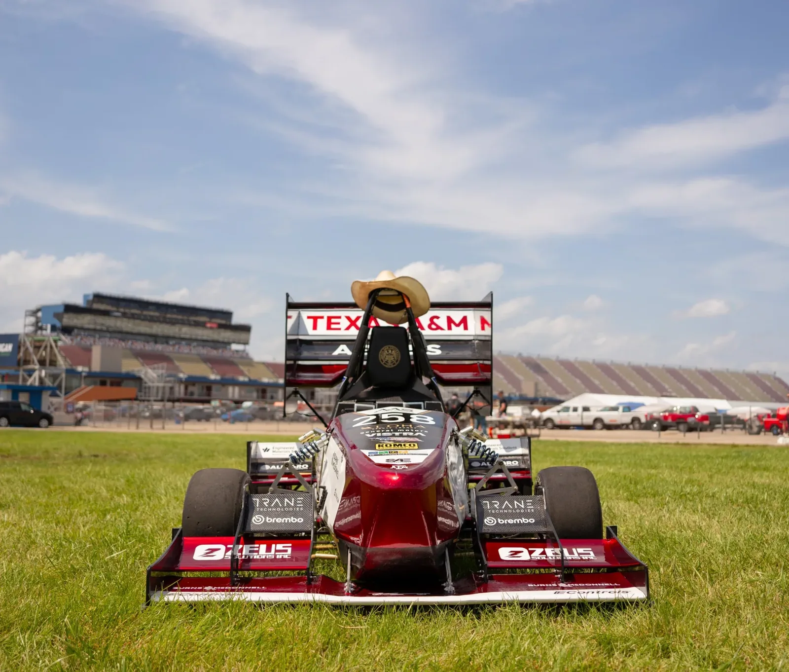 The Texas A&M car on the grass at the speedway