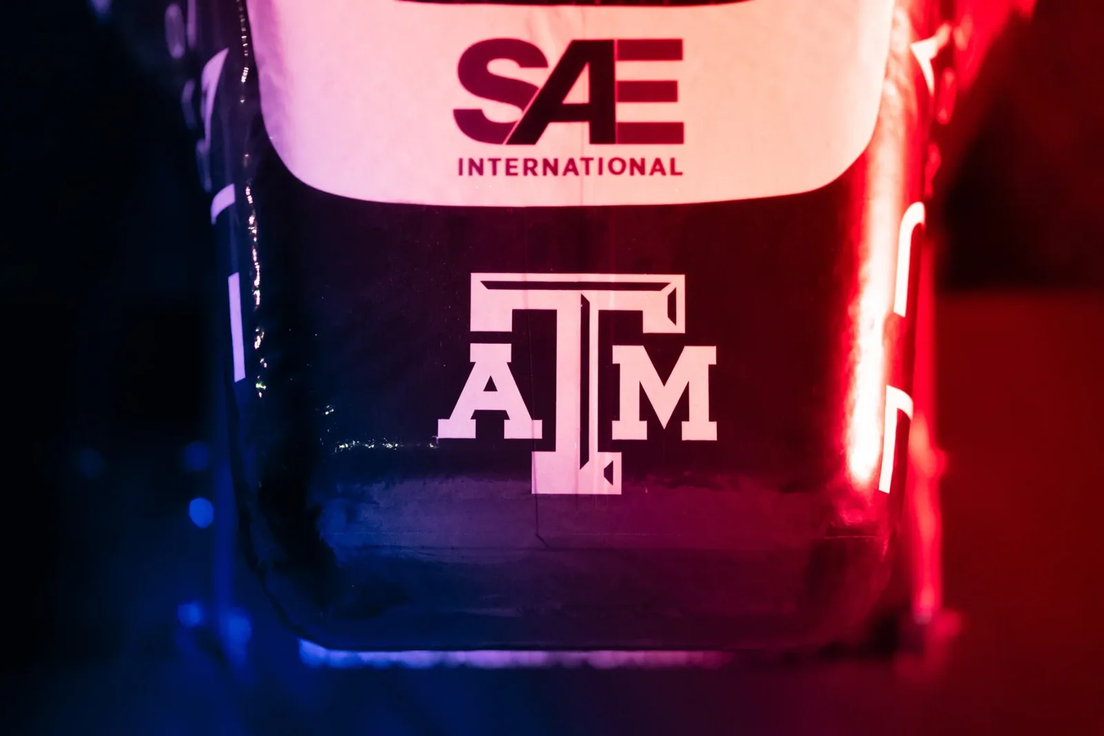 SAE and Texas A&M logos on the nose, lit in red and blue