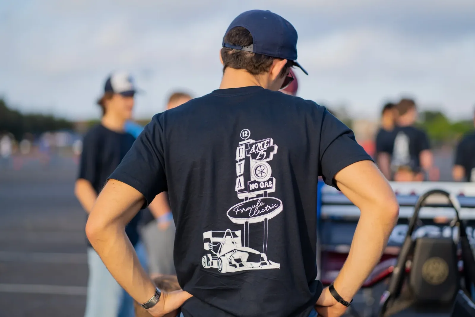 Back of a black shirt with a race car and Formula Electric sign graphic