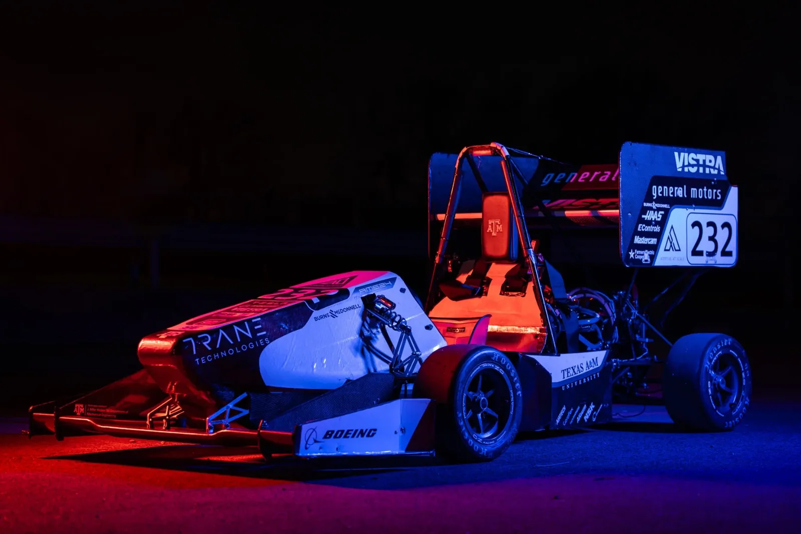 Car 232 lit in red and blue on a dark set