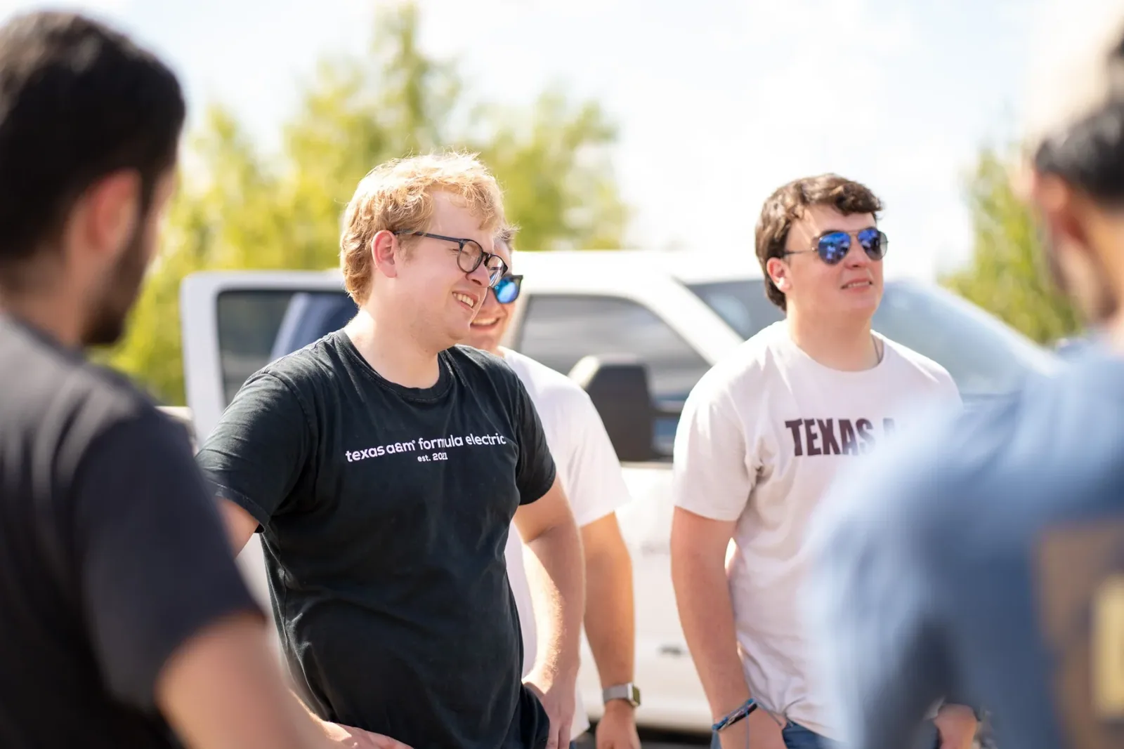 Team members talking in the parking lot between runs