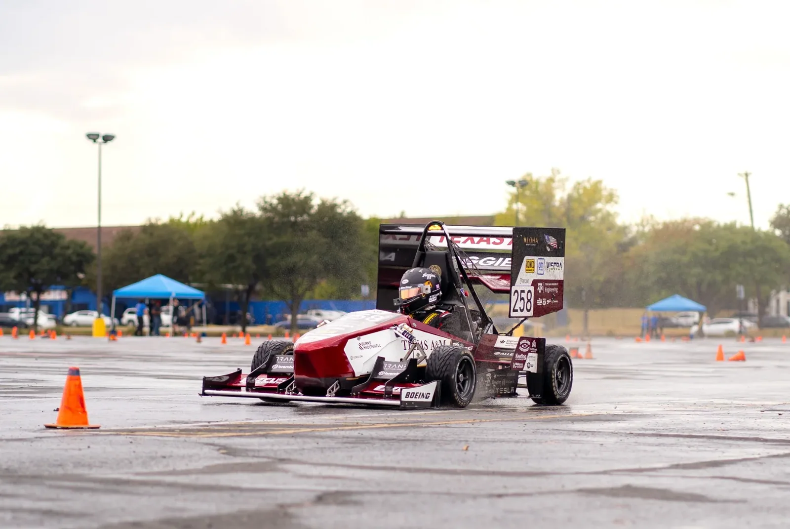 The car sliding past a cone on the autocross course at sunset